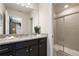 Bathroom featuring granite countertops, dark wood cabinetry, shower, and view to a bedroom at 4157 Lana Ave, Davenport, FL 33897