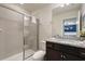 Bright bathroom featuring a tiled shower with glass door and granite vanity at 4157 Lana Ave, Davenport, FL 33897