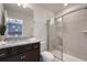 Bright bathroom featuring a tiled shower with glass door and granite vanity at 4157 Lana Ave, Davenport, FL 33897