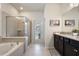 Bright bathroom with granite counters, double vanity, tile shower, and tub at 4157 Lana Ave, Davenport, FL 33897