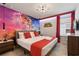 Bedroom featuring a Super Mario Bros theme, king bed, red bedding, and side tables at 4157 Lana Ave, Davenport, FL 33897