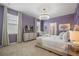 Bedroom with large bed, custom trim, elegant chandelier, and bright natural light at 4157 Lana Ave, Davenport, FL 33897