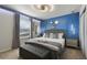 A modern bedroom that is stylishly decorated with an accent wall, bed, and lighting at 4157 Lana Ave, Davenport, FL 33897