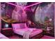 Themed bedroom featuring a whimsical mural, unique lighting, and comfortable bedding at 4157 Lana Ave, Davenport, FL 33897