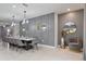 Elegant dining room with a large table, stylish chairs, and decorative wall paneling at 4157 Lana Ave, Davenport, FL 33897