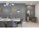 Close-up of dining room featuring modern lighting, table setting, and decorative wall elements at 4157 Lana Ave, Davenport, FL 33897