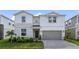 Beautiful two-story home boasts stone accents, manicured landscaping, and a two-car garage at 4157 Lana Ave, Davenport, FL 33897