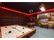 A Gathering game room has a foosball table, air hockey, flat screen TV, and themed decor at 4157 Lana Ave, Davenport, FL 33897