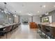 Open-concept living room with dining area, modern lighting, and access to outdoor seating and pool at 4157 Lana Ave, Davenport, FL 33897