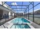 Enjoy the luxurious pool and spa area, complete with a screened enclosure and charming string lights for added ambiance at 4157 Lana Ave, Davenport, FL 33897