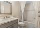 Bright bathroom featuring a walk-in shower and a large mirror above the vanity at 421 E Gore St, Orlando, FL 32806