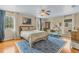 Bright bedroom featuring a ceiling fan, hardwood floors, and a large window overlooking the yard at 421 E Gore St, Orlando, FL 32806