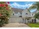 Charming two-story home with manicured lawn, two-car garage and mature trees adding curb appeal at 421 E Gore St, Orlando, FL 32806