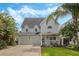 Charming two-story home with manicured lawn, two-car garage and mature trees adding curb appeal at 421 E Gore St, Orlando, FL 32806