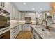 White kitchen with marble countertops, stainless steel appliances, and custom cabinets at 421 E Gore St, Orlando, FL 32806