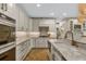 White kitchen with marble countertops, stainless steel appliances, and custom cabinets at 421 E Gore St, Orlando, FL 32806