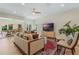 Spacious living room with modern ceiling fan open to formal dining room, offering comfortable living space at 421 E Gore St, Orlando, FL 32806