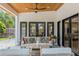 A cozy outdoor living area with seating and a view of the landscaped backyard at 421 E Gore St, Orlando, FL 32806