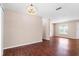 Bright open-plan living room boasts wood floors, neutral walls, window, and a seamless flow into the kitchen at 4363 Cassius St, Orlando, FL 32811