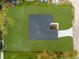 Aerial view of a home with a dark roof, green grass and new landscaping at 4944 Tinkham Ave, Orlando, FL 32812