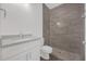 Bathroom featuring a shower, toilet and single sink vanity at 4944 Tinkham Ave, Orlando, FL 32812