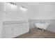 Bathroom features a clawfoot tub, double sinks and white cabinets at 4944 Tinkham Ave, Orlando, FL 32812