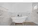Bathroom with claw foot tub, marble tile and shower at 4944 Tinkham Ave, Orlando, FL 32812