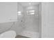 Modern bathroom featuring a glass shower with marble-look tile and stylish fixtures at 4944 Tinkham Ave, Orlando, FL 32812