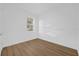 Empty bedroom with wood floors, a window, and neutral paint at 4944 Tinkham Ave, Orlando, FL 32812