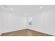 Bright bedroom with light wood floors and a single window providing natural light at 4944 Tinkham Ave, Orlando, FL 32812