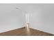 Empty bedroom featuring wood flooring and a view to another room at 4944 Tinkham Ave, Orlando, FL 32812