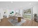 Bright dining area features stylish furniture, sleek flooring and a large sliding glass door to the backyard at 4944 Tinkham Ave, Orlando, FL 32812