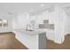 Bright kitchen featuring a large island, quartz countertops, and white cabinetry at 4944 Tinkham Ave, Orlando, FL 32812