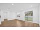 Open concept living room with large windows and sliding glass doors to backyard at 4944 Tinkham Ave, Orlando, FL 32812