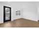 Bright and airy living room features stylish flooring, fresh white paint and ample natural light at 4944 Tinkham Ave, Orlando, FL 32812