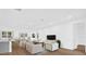 Bright, staged living room with an open layout, contemporary furniture, and sleek flooring at 4944 Tinkham Ave, Orlando, FL 32812