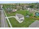 Aerial view of a home with green lawn in a neighborhood of mature trees at 495 Dean Creek Ln, Orlando, FL 32825