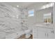 A remodeled bathroom with white marble shower, new tile, and white vanity at 495 Dean Creek Ln, Orlando, FL 32825