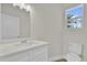 Bright bathroom featuring new vanity, quartz countertop, white sink and window at 495 Dean Creek Ln, Orlando, FL 32825