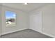 Bright bedroom with gray carpet, white trim, and a closet at 495 Dean Creek Ln, Orlando, FL 32825