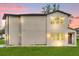 Two-story home with large windows providing ample natural light and a well-manicured lawn at 495 Dean Creek Ln, Orlando, FL 32825