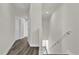 Hallway and stairwell with modern gray wood-look flooring and white trim at 495 Dean Creek Ln, Orlando, FL 32825