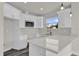 Bright kitchen features white cabinets, a modern microwave and a gleaming quartz countertop at 495 Dean Creek Ln, Orlando, FL 32825