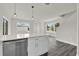 Open kitchen with stainless steel dishwasher, white cabinets, and large quartz countertop island at 495 Dean Creek Ln, Orlando, FL 32825