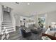 Open-concept living area flows into a modern kitchen with a staircase leading to the upper level at 495 Dean Creek Ln, Orlando, FL 32825