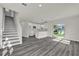 Open-concept living area with a modern kitchen and sliding glass doors to the backyard at 495 Dean Creek Ln, Orlando, FL 32825