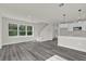 Open-concept living space with a modern kitchen, staircase, and large windows for plenty of light at 495 Dean Creek Ln, Orlando, FL 32825