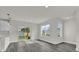 Bright living area with modern flooring, sliding doors to the backyard, and a view of the kitchen at 495 Dean Creek Ln, Orlando, FL 32825