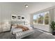 Serene main bedroom featuring a plush bed, stylish decor, and large windows for natural light at 495 Dean Creek Ln, Orlando, FL 32825