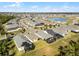 A picturesque aerial view of a neighborhood boasts serene lake views, orderly streets, and well-kept homes with screened patios at 5159 Twin Lakes Blvd, St Cloud, FL 34772